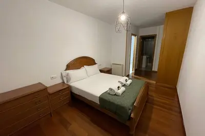 a bedroom with a bed with two towels on it at Oktheway Calvo Sotelo in Sarria