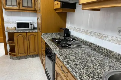 a kitchen with a stove and a microwave at Oktheway Calvo Sotelo in Sarria