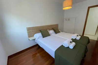 a bedroom with two beds with towels on them at Oktheway Calvo Sotelo in Sarria