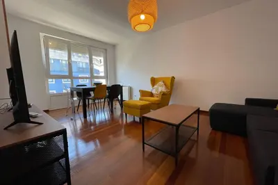 a living room with yellow chairs and a table at Oktheway Calvo Sotelo in Sarria