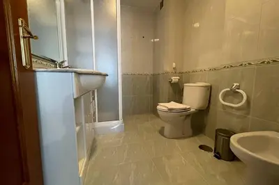 a bathroom with a toilet and a sink at Oktheway Calvo Sotelo in Sarria