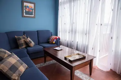 a living room with a blue couch and a coffee table at Casa Morazón Fontán Sada in Sada