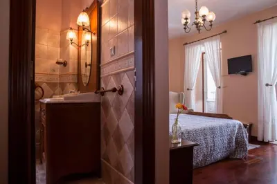 a bedroom with a bed and a sink and a mirror at Casa Morazón Fontán Sada in Sada