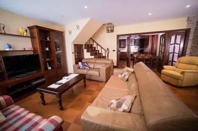 a living room with a couch and a tv at Casa Morazón Fontán Sada in Sada