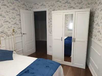 a bedroom with a bed and a glass door at Casa Honorio in Santa Marina del Sil