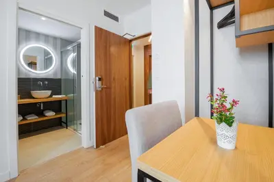 a dining room with a table and a sink at Hotel Condado Ourense in Ourense