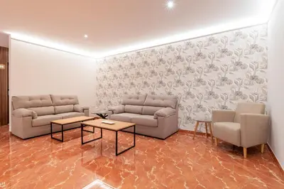 a living room with two couches and two tables at Hotel Condado Ourense in Ourense