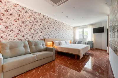 a living room with a couch and a bed at Hotel Condado Ourense in Ourense