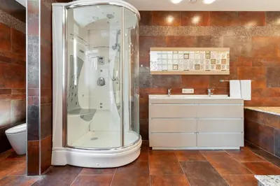 a bathroom with a shower and a toilet and a sink at Hotel Condado Ourense in Ourense