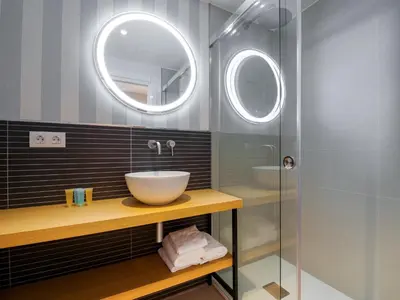 a bathroom with a sink and a mirror at Hotel Condado Ourense in Ourense