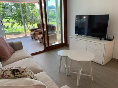 a living room with a couch and a tv and a table at Casa O Pazo - Rural - Camino Norte - Boimorto in Boimorto