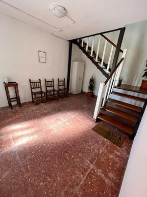 an empty room with stairs and chairs in it at Casa Lola in Teo