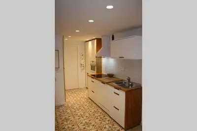 a kitchen with white cabinets and a sink at CASA REHABILITADA EN CASCO HISTÓRICO in Santiago de Compostela