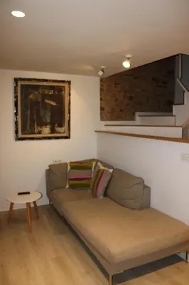 a living room with a couch and a table at CASA REHABILITADA EN CASCO HISTÓRICO in Santiago de Compostela