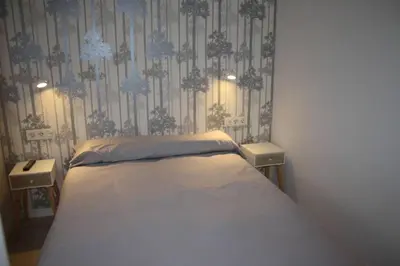 a bedroom with a bed and two night stands at CASA REHABILITADA EN CASCO HISTÓRICO in Santiago de Compostela