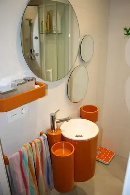 a bathroom with an orange sink and a mirror at CASA REHABILITADA EN CASCO HISTÓRICO in Santiago de Compostela