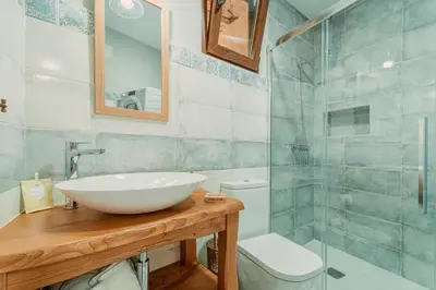 a bathroom with a sink and a glass shower at Casa Escondida Aveiga in Chantada