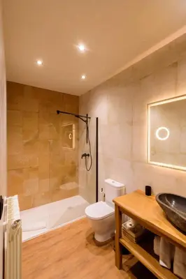 a bathroom with a tub and a toilet and a sink at Casa Escondida Aveiga in Chantada