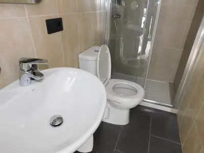 a bathroom with a toilet and a sink and a shower at HOTEL TERRA GALEGA MEIGA in Monforte de Lemos