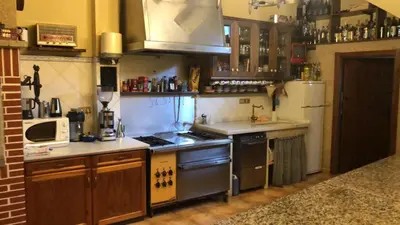 a kitchen with a stove and a refrigerator at CASA DE MELCHOR in Cruces