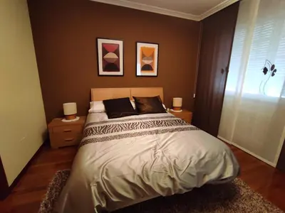 a bedroom with a bed with two night stands and a window at CASA DE MELCHOR in Cruces