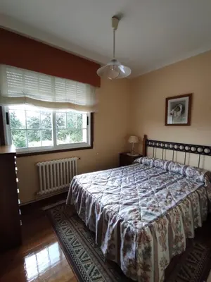 a bedroom with a bed and two windows at CASA DE MELCHOR in Cruces