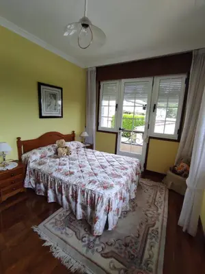 a bedroom with a bed with a teddy bear on it at CASA DE MELCHOR in Cruces