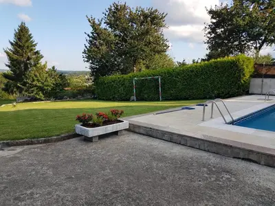 a swimming pool with a bench and flowers in a yard at CASA DE MELCHOR in Cruces