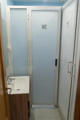 a bathroom with a shower and a white sink at Hostal Santa Cruz in Santiago de Compostela