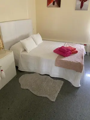 a bedroom with a bed with two pillows on it at Villa Bimba, alojamiento con piscina y barbacoa in Caldas de Reis