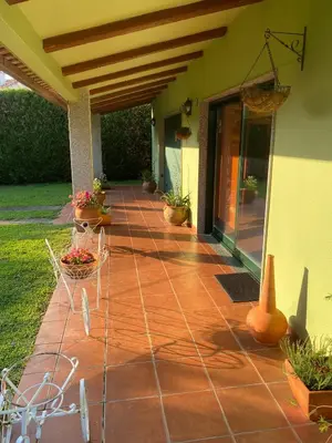 a porch with a brick walkway with potted plants at Villa Bimba, alojamiento con piscina y barbacoa in Caldas de Reis