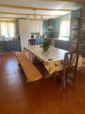 a kitchen with a large wooden table and chairs at Villa Bimba, alojamiento con piscina y barbacoa in Caldas de Reis