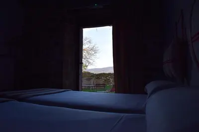 a bedroom with two beds and a window with a view at CASA SOLANCE in Sarria
