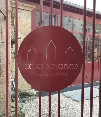 a sign on a gate in front of a building at CASA SOLANCE in Sarria