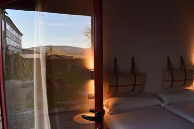 a bedroom with a window with a bed and a view at CASA SOLANCE in Sarria