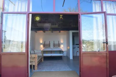 a red door leading into a room with a bedroom at CASA SOLANCE in Sarria