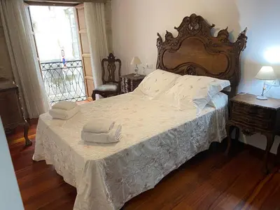 a bedroom with a large bed with two hats on it at SE@SE a 100m.Catedral. in Santiago de Compostela