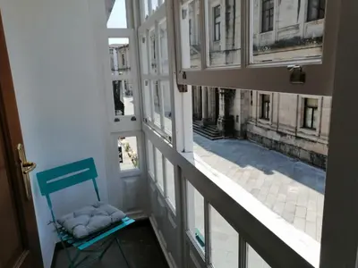 a room with a chair and a view of a street at SE@SE a 100m.Catedral. in Santiago de Compostela