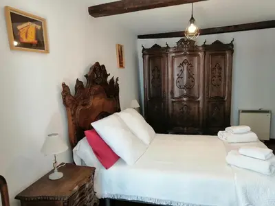 a bedroom with a large bed and a wooden cabinet at SE@SE a 100m.Catedral. in Santiago de Compostela