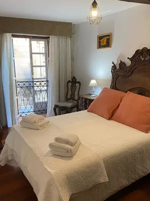 a bedroom with a bed with towels on it at SE@SE a 100m.Catedral. in Santiago de Compostela