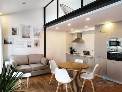 a living room with a couch and a table at Cabanela Maitia Apto Telmo Duplex in Ribadeo