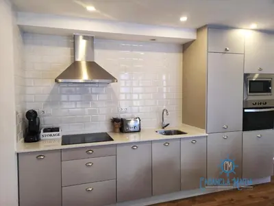 a kitchen with a sink and a stove top oven at Cabanela Maitia Apto Telmo Duplex in Ribadeo