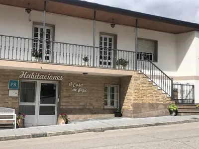 a building with a sign on the side of it at Habitaciones A Casa de Pepe in Tríacastela