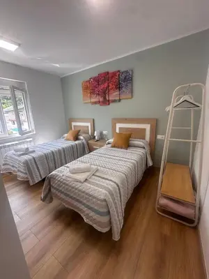 a room with two beds and a ladder in it at Habitaciones A Casa de Pepe in Tríacastela