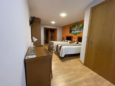 a room with two beds and a hallway with two beds at Habitaciones A Casa de Pepe in Tríacastela