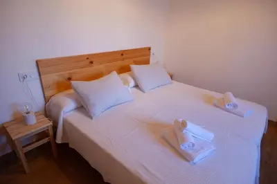 a bedroom with two beds with towels on them at CASA TERRA ALMA in Laza