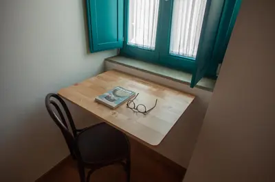 a table with a pair of glasses and a book on it at CASA TERRA ALMA in Laza
