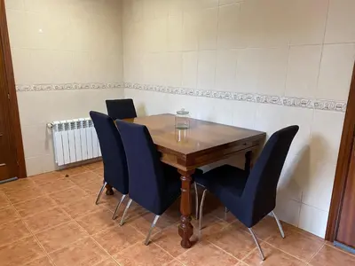 a wooden table with chairs and a wine glass on it at Fonte do Torno in A Coruña