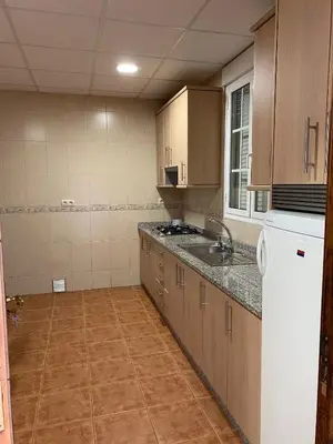an empty kitchen with a sink and a refrigerator at Fonte do Torno in A Coruña