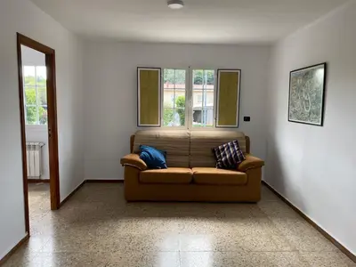 a living room with a couch and two windows at Fonte do Torno in A Coruña